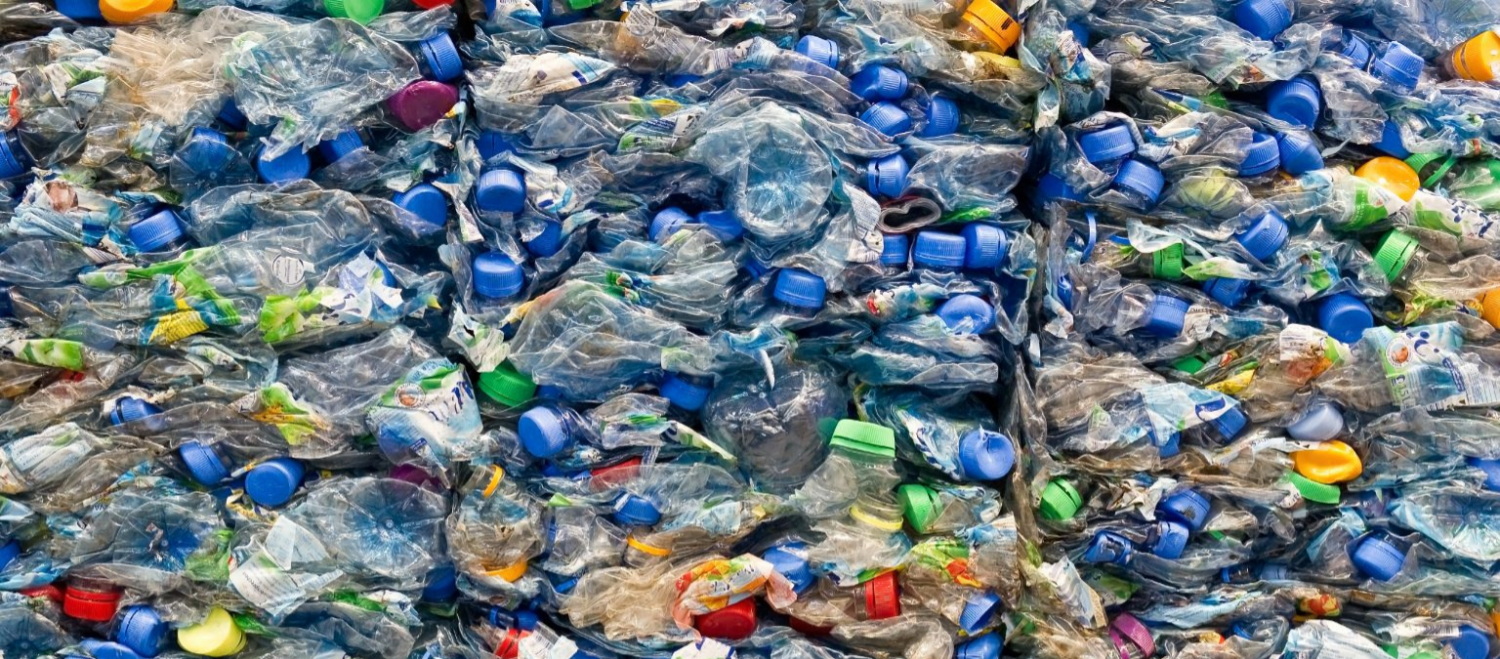 upclose shot of plastic bottles crushed and baled for commercial recycling